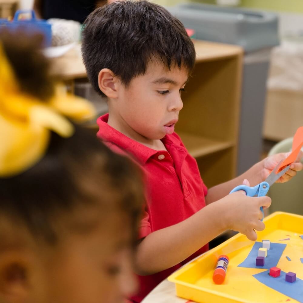 Child engaged in an art activity, encouraging creativity and self-expression.